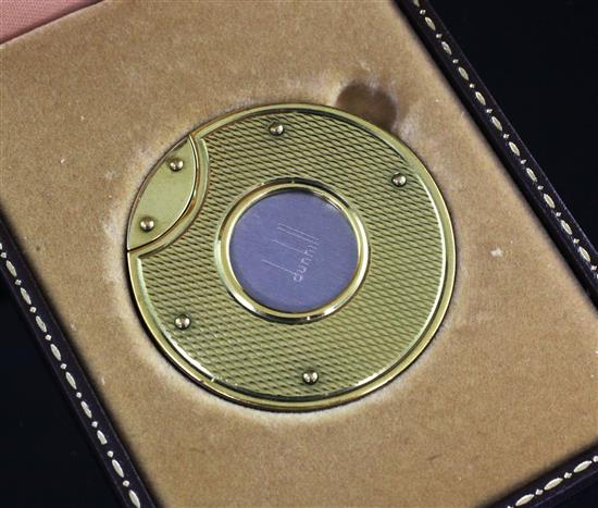 A cased Dunhill gold mounted stainless steel cigar cutter, dia. 1.75in.